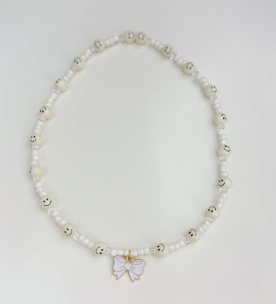 White smilies & bow charm toddler necklace